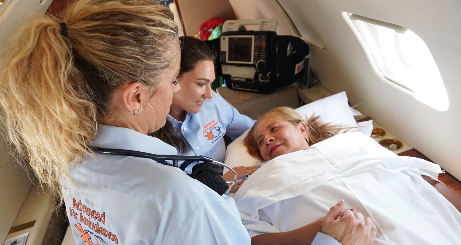 Image of the Advanced Air Ambulance crew loading a patient onto a private air ambulance plane.